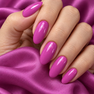 Hand mit glänzenden Nägeln in dunklem Flieder Lila auf violettem Satin – Rockstar Nails 3in1 UV Gellack 90018.